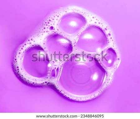 Foam soap bubbles on purple background. Liquid soap bubble, Froth background, top view. Soap foam popping. Soap sud macro structure, close-up. Clean, cleaning, washing. Bright Pink backdrop Royalty-Free Stock Photo #2348846095