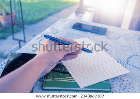 Closeup of woman's hand on the terrace table. High quality photo