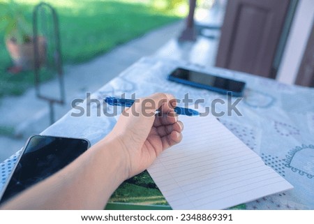 Closeup of woman's hand on the terrace table. High quality photo