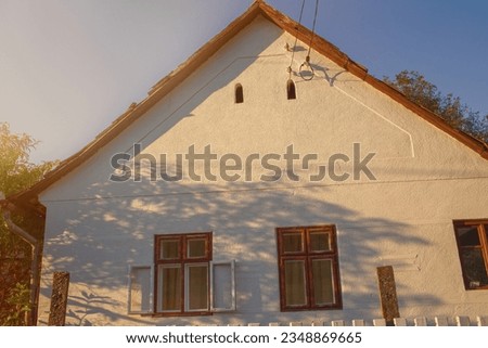 Facade of old peasant house in autumn season. High quality photo