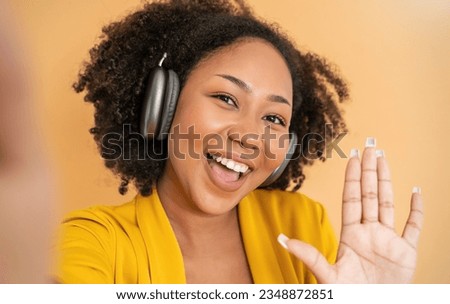 Portrait of beautiful  successful business African black girl in yellow suit selfie celebrate with head phone listen to music. Success and happy woman internet technology startup business. 
