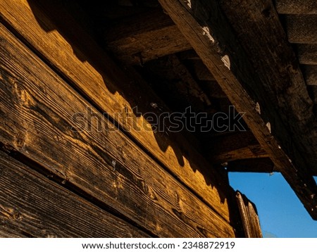 The overhang of the roof of an old abandoned house. Graphics in photography, diagonal composition.