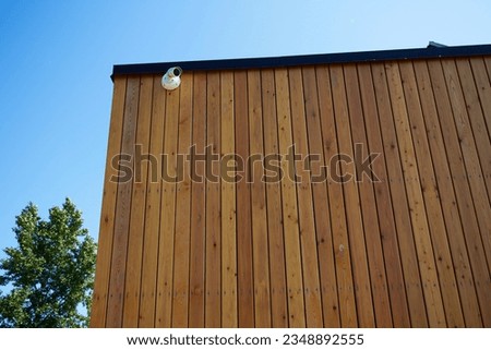Photo security camera on wall of house. Rack surface of wall. Safe private property. Royalty-Free Stock Photo #2348892555