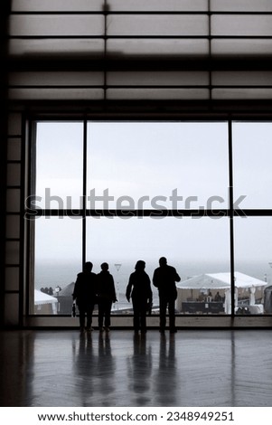 Silhouettes of people in a modern building