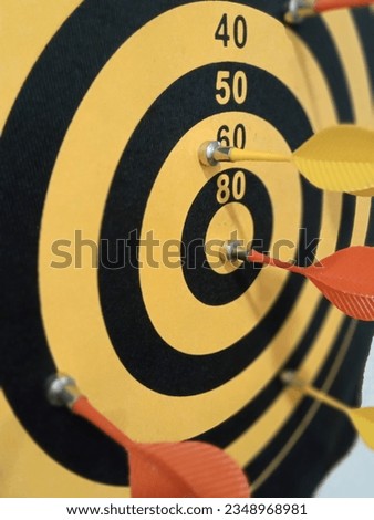 Arrows on black and yellow bulls eye  Royalty-Free Stock Photo #2348968981