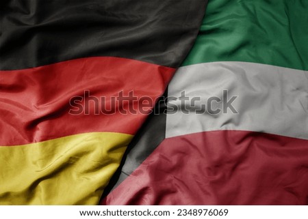 big waving realistic national colorful flag of germany and national flag of kuwait . macro