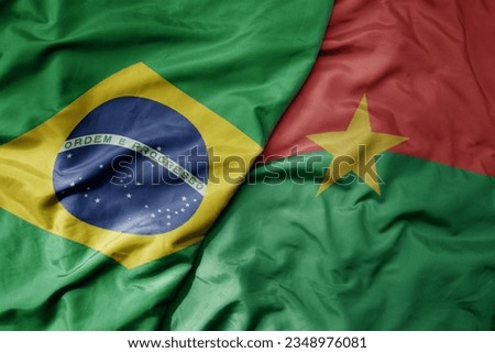 big waving realistic national colorful flag of brazil and national flag of burkina faso . macro