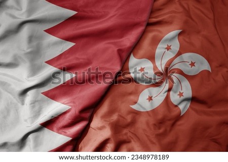 big waving realistic national colorful flag of bahrain and national flag of hong kong . macro