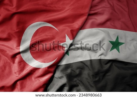big waving national colorful flag of turkey and national flag of syria . macro