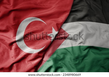big waving national colorful flag of turkey and national flag of palestine . macro