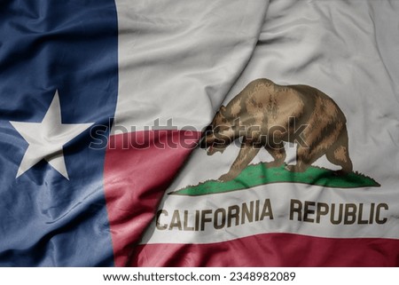 big waving colorful national flag of california state and flag of texas state . macro