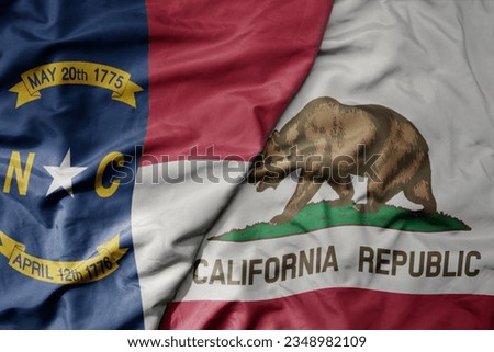 big waving colorful national flag of california state and flag of north carolina state . macro