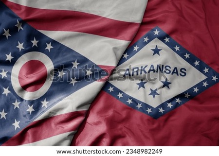 big waving colorful national flag of arkansas state and flag of ohio state . macro
