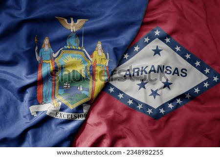 big waving colorful national flag of arkansas state and flag of new york state . macro