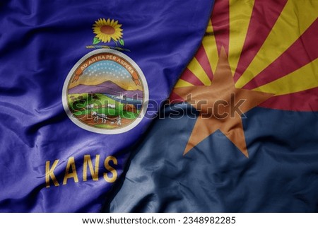 big waving colorful national flag of arizona state and flag of kansas state . macro