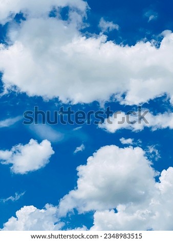 The afternoon sky is vertical with white clouds. bright sky background