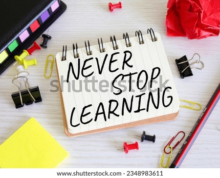 Never stop learning symbol. Concept words Never stop learning on wooden notebook. Beautiful wooden background. Business and Never stop learning concept. Copy space.