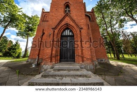 General view and close-up architectural details of the Catholic Church of St. Holy Trinity in the town of Dwawrzuty in Masuria in Poland.