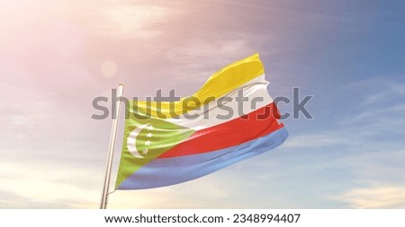 Comoros national flag waving in beautiful sky.