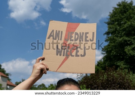 Female protester with placard sign supporting abortion rights in Poland. Women's Strike protest rally demonstration after death of young pregnant woman. Ani jednej więcej, means Not one more.