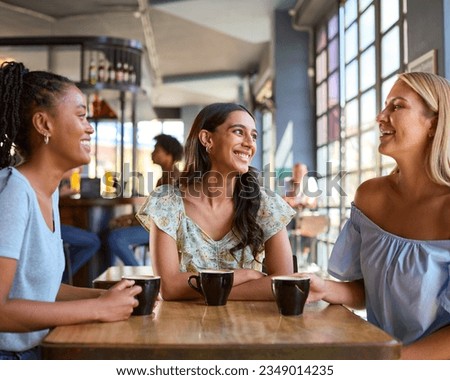 Multi-Cultural Group Of Female Friends Meeting And Catching Up In Restaurant Or Coffee Shop Royalty-Free Stock Photo #2349014235