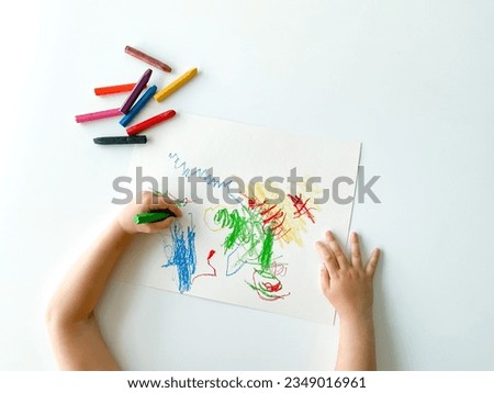 small child draws with pastel crayons on white table. fathers day Royalty-Free Stock Photo #2349016961