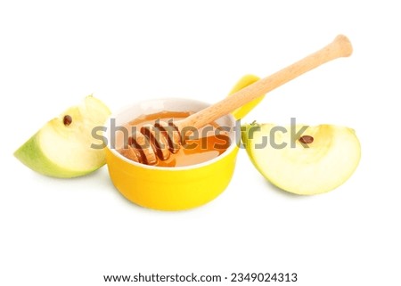 Bowl of honey and apple for Rosh Hashanah celebration (Jewish New Year) on white background