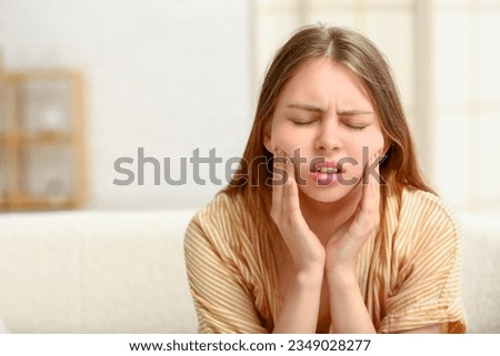 Young woman suffering from  toothache at home Royalty-Free Stock Photo #2349028277