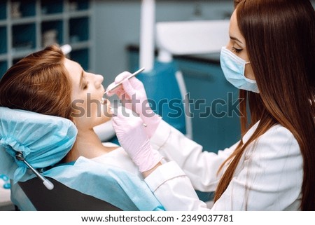 Professional woman dentist is working. Woman patient during a dental procedure. Dental care. Overview of caries prevention. Royalty-Free Stock Photo #2349037781