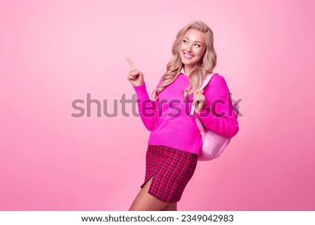 Photo of lovely positive girl wavy hairdo wear stylish clothes skirt look up empty space school courses isolated on pink color background