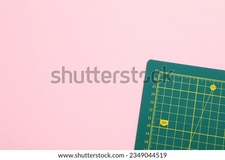 Patchwork accessories concept on pink background, mat cutting