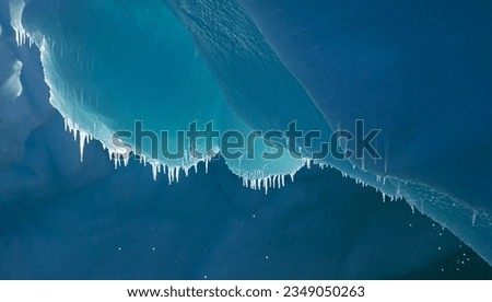 Icicle detail; Cape Adare, Antarctica; Icicles above, an aqua grotto, in an iceberg; Cape Adare, Antarctica Bay