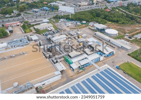 Aerial top view of concrete industry factory in urban city town. Business distribution logistic transport in Thailand.