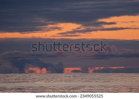 Red sunrise, behind icebergs, and mountains; Cape Adare, Antarctica Bay; Sunset clouds; Ross Sea, Antarctica; Tabular iceberg, clouds, mountain ridges; Cape Adare, Antarctica