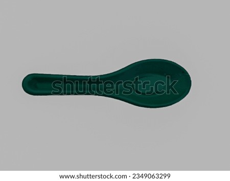 green duck spoon on a white background