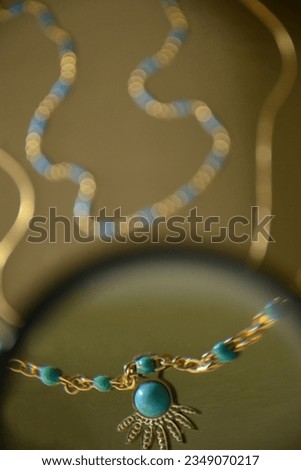 Jewelry with blue stones under a magnifying glass