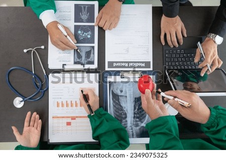 The medical attended a meeting with a team of cardiologists to discuss surgery plans for a heart patient after the medical team discovered a leaky heart valve and requires urgent medical attention. Royalty-Free Stock Photo #2349075325
