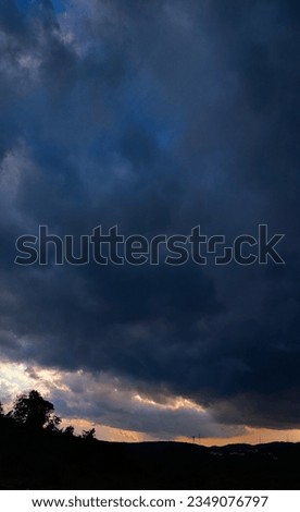 selective focus picture of sunset with dense deep blue clouds