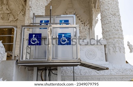 Accessible Elevator with sign. Disabled persons lift near modern apartment facility. The special elevator for the disabled at the entrance to the living house. Equipment with the wheelchair.