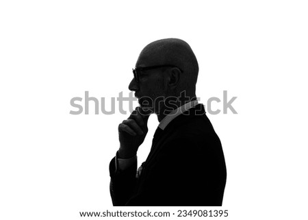 Silhouette of thoughtful elderly caucasian businessman.