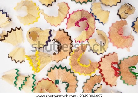 Macro photo pencil shavings on a white background with colored pencils. Concept: Art, background, wallpaper, mockup, drawing, creativity, education, development, artist