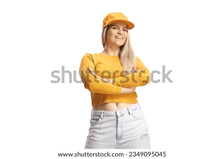 Young female with a cap and yellow top posing isolated on white background