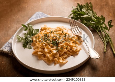 butterfly pasta with smoked salmon cream sauce and parsley Royalty-Free Stock Photo #2349100833