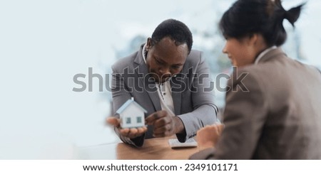 African american real estate agent showing house to his clients after contract signing, concept for real estate, moving house or renting property with diversity ethnicity