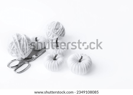 White handmade textile pumpkins. Halloween card. Happy Halloween.Hobby background with handmade pumpkins. DIY, craft decoration for fall and winter holidays.