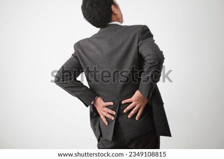 Business image of a middle-aged man with back pain