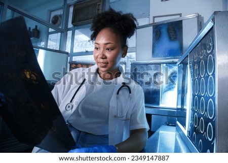 Female medical radiologist doctor looking head and brain x-ray film before surgery in lab office at hospital. Healthcare and education. Royalty-Free Stock Photo #2349147887