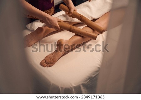 Wellness center masseuse giving leg massage to female