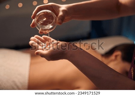 Experienced spa therapist getting patient ready for aromatherapy massage