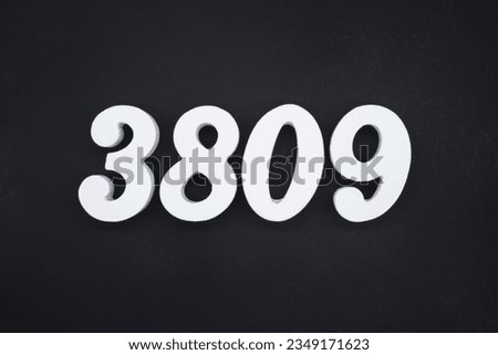 Black for the background. The number 3809 is made of white painted wood.